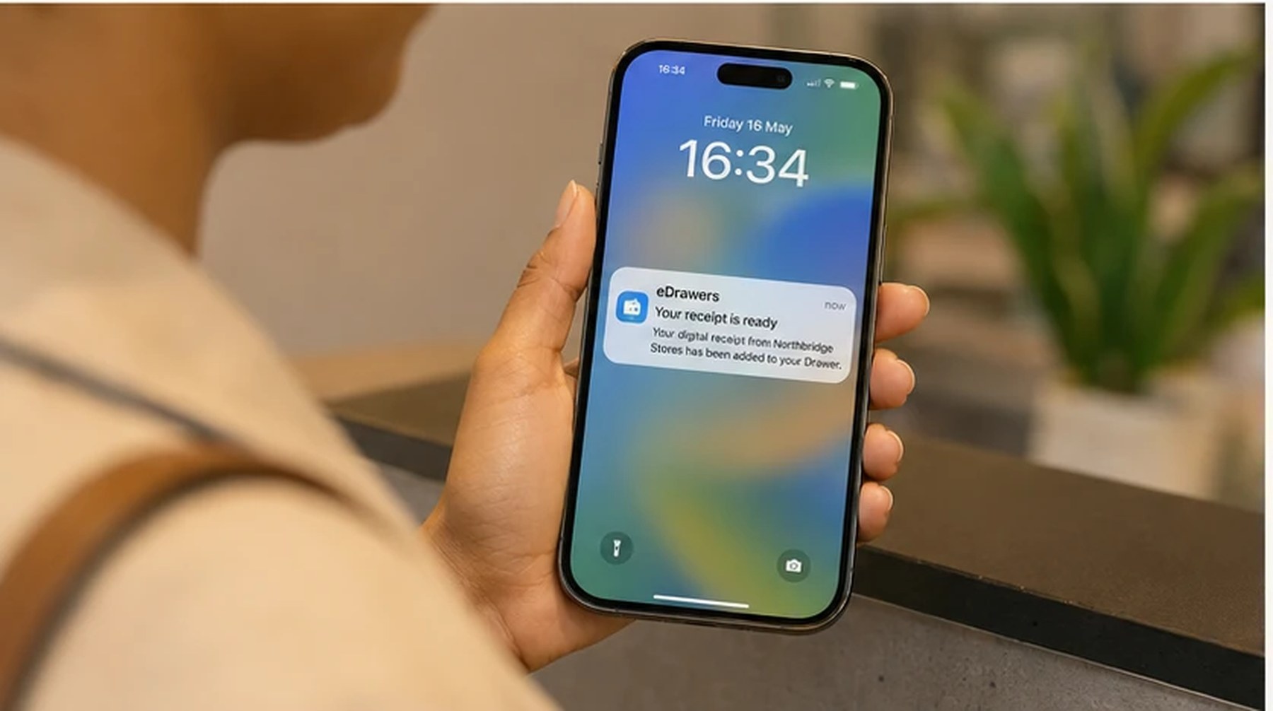 A phone notification confirms an eDrawers digital receipt has arrived
